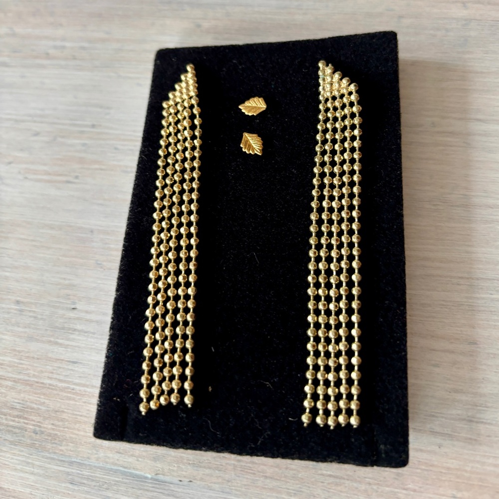 Two sets of earrings: gold drop chain earrings & leaf studs.